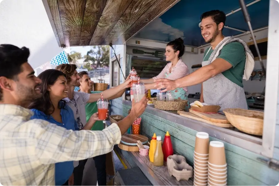 waitress and waiter giving juice to customers